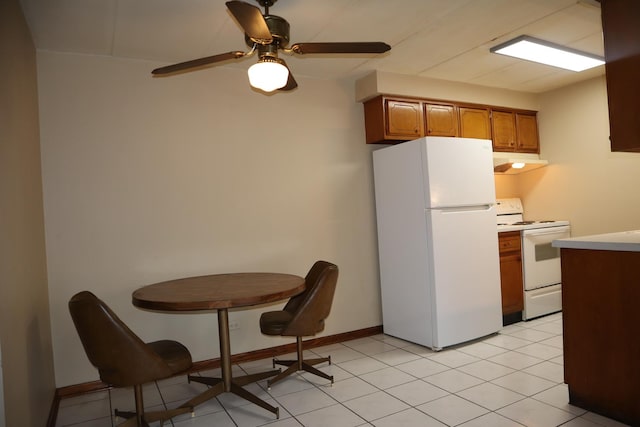 kitchen with ceiling fan, light tile patterned flooring, and white appliances