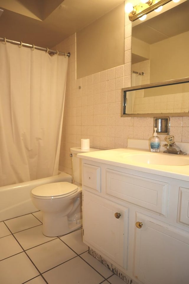 full bathroom with tile patterned flooring, vanity, shower / bath combination with curtain, tile walls, and toilet