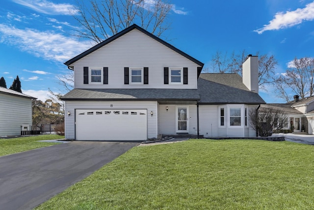 front facade with a garage and a front lawn