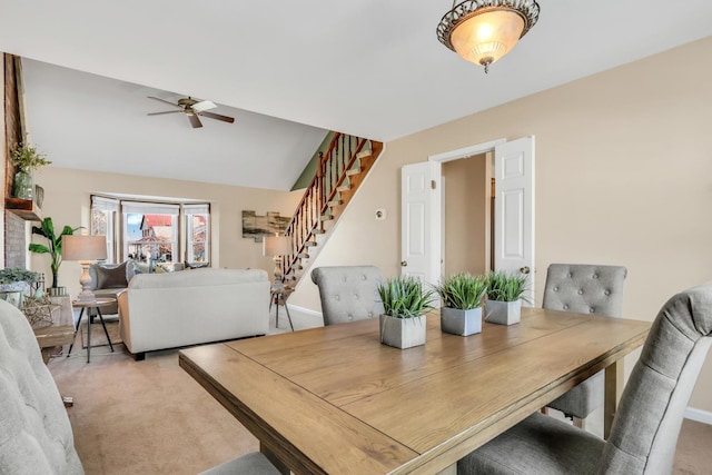 dining room with lofted ceiling, ceiling fan, and carpet