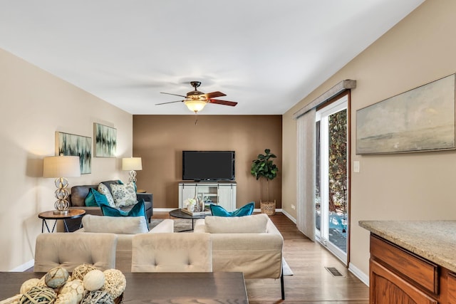 living room with hardwood / wood-style flooring and ceiling fan