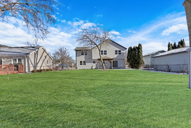 rear view of property featuring a yard