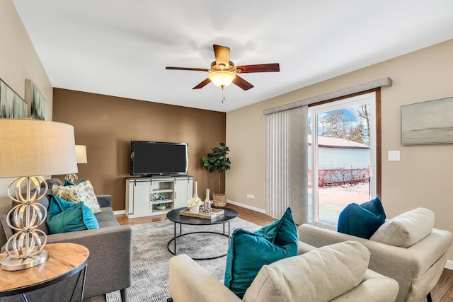 living room featuring hardwood / wood-style floors and ceiling fan