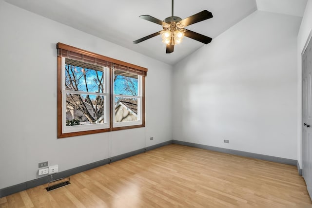 spare room with lofted ceiling, ceiling fan, and light hardwood / wood-style flooring