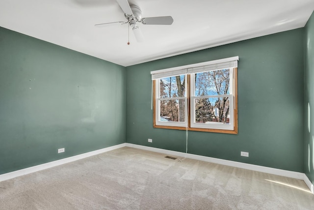 unfurnished room featuring ceiling fan and carpet