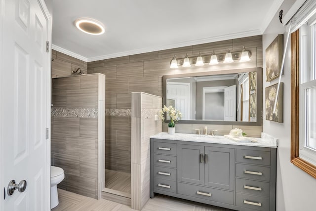 bathroom featuring toilet, a shower, crown molding, and vanity