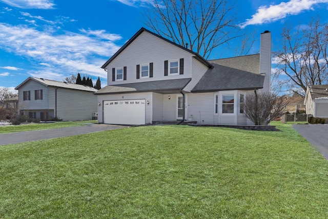 view of property with a front lawn and a garage