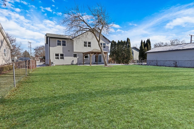 rear view of house with a lawn and a gazebo