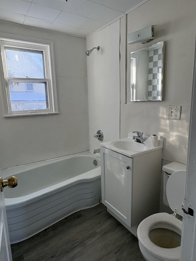 full bathroom with vanity, hardwood / wood-style flooring, shower / tub combination, and toilet