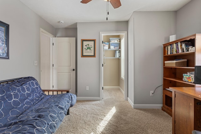 sitting room with ceiling fan and light carpet