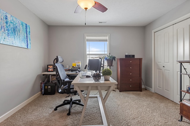 office space featuring ceiling fan and light carpet