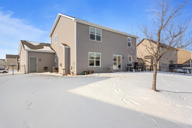 view of snow covered back of property