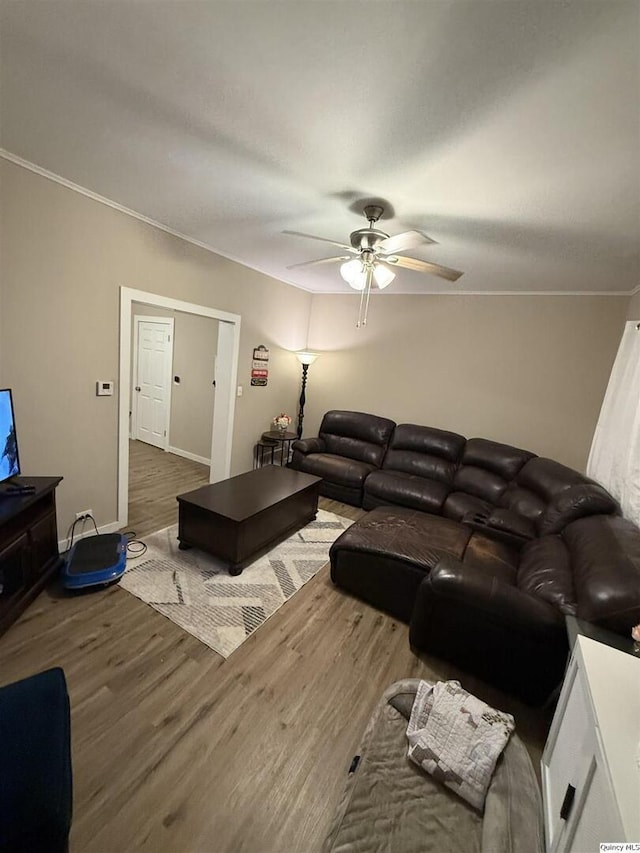 living room featuring ceiling fan, crown molding, and dark hardwood / wood-style flooring