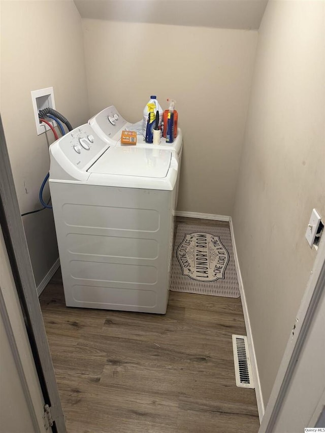 laundry area featuring dark hardwood / wood-style floors and washer and dryer