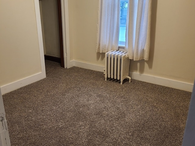 407 E Walnut St, Oglesby, IL 61348 - unfurnished bedroom featuring radiator heating unit, carpet flooring, and baseboards