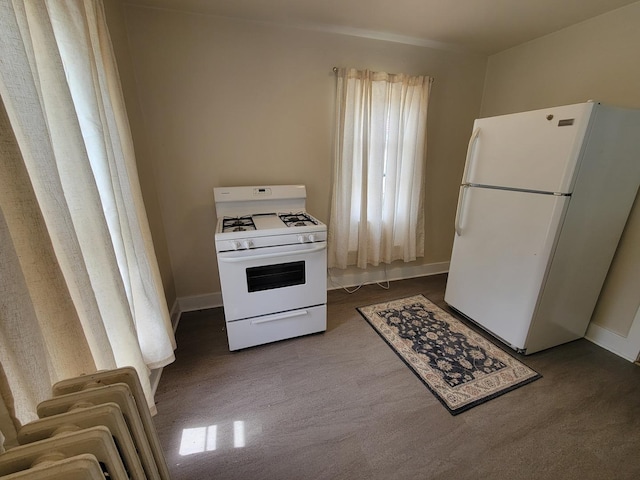 407 E Walnut St, Oglesby, IL 61348 - kitchen featuring white appliances, baseboards, and dark carpet