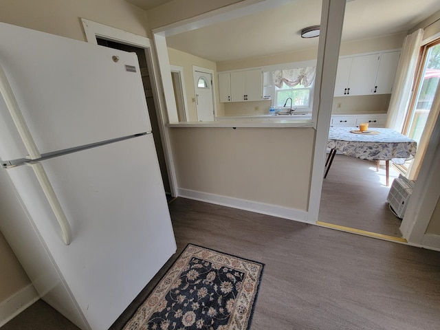 407 E Walnut St, Oglesby, IL 61348 - kitchen with freestanding refrigerator, plenty of natural light, light countertops, and white cabinetry
