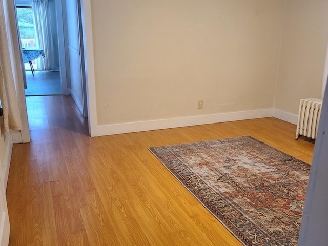 407 E Walnut St, Oglesby, IL 61348 - unfurnished room featuring radiator, baseboards, and light wood-type flooring