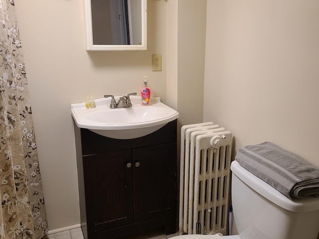 407 E Walnut St, Oglesby, IL 61348 - bathroom with radiator, vanity, and toilet