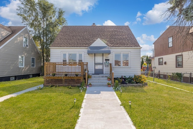 bungalow-style house with a front yard and a wooden deck