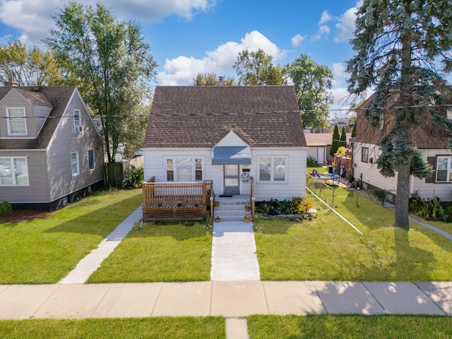 view of front of property with a deck and a front lawn