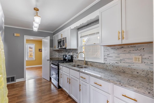 kitchen featuring light stone counters, stainless steel appliances, white cabinets, and sink