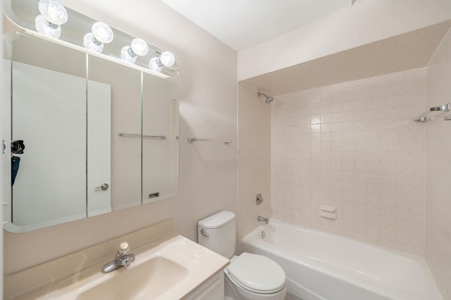 full bathroom featuring toilet, tiled shower / bath combo, and vanity