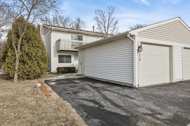 exterior space with a balcony and a garage