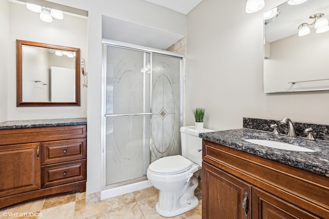 bathroom with a shower with shower door, toilet, and vanity