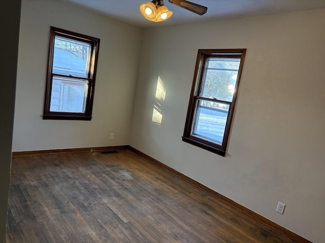 empty room featuring dark hardwood / wood-style flooring and ceiling fan