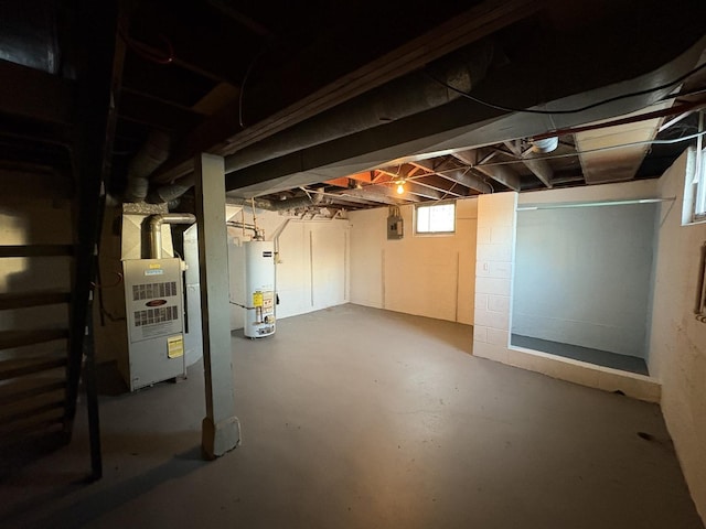 basement featuring heating unit, gas water heater, and electric panel