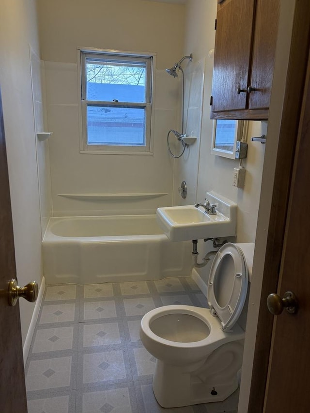 bathroom featuring toilet and bathing tub / shower combination