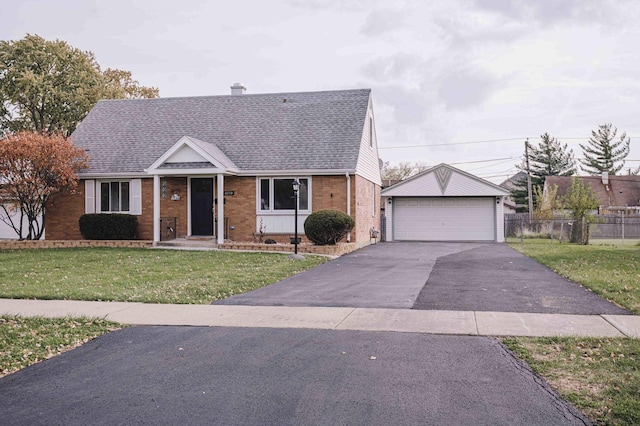 view of front of property featuring a garage and a front lawn