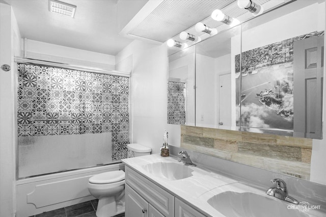 full bathroom with toilet, tile patterned floors, combined bath / shower with glass door, and vanity