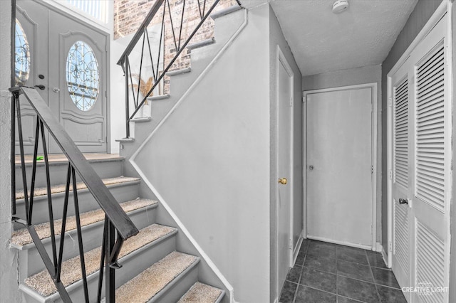 stairs with tile patterned floors