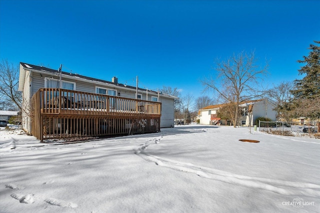 snow covered property with a deck