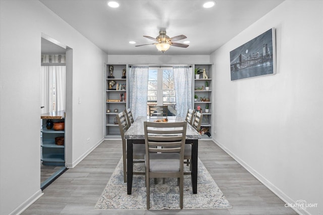 dining room with ceiling fan and light hardwood / wood-style flooring