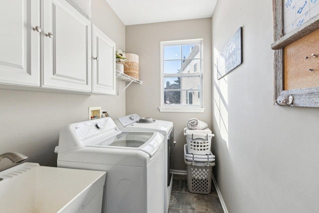 clothes washing area with cabinets, sink, and washing machine and dryer