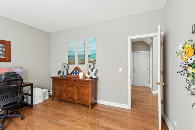 home office with light hardwood / wood-style floors