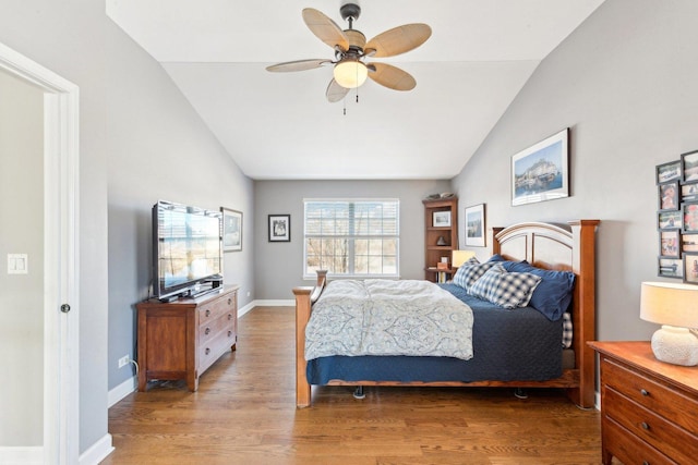 bedroom with vaulted ceiling, ceiling fan, and hardwood / wood-style floors