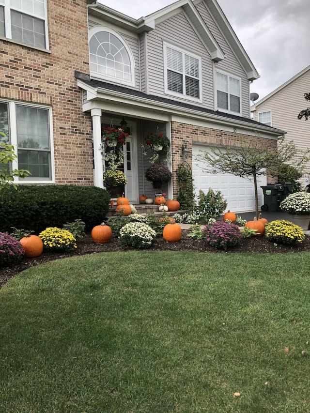 view of front of home featuring a garage and a front yard