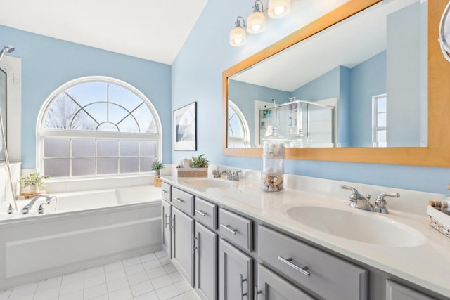 bathroom with lofted ceiling, vanity, tile patterned floors, and separate shower and tub