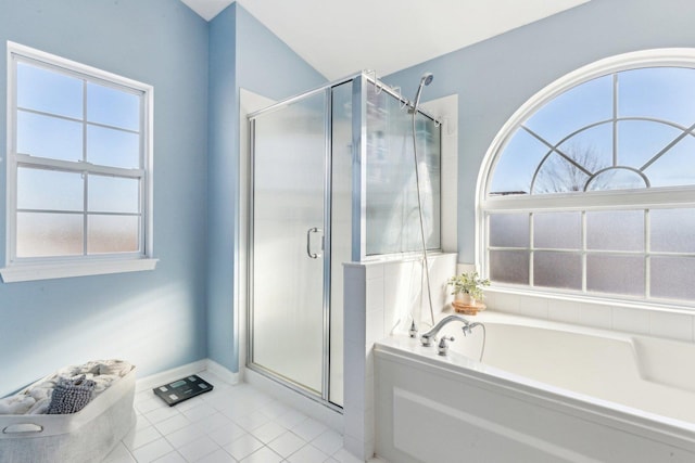 bathroom featuring tile patterned flooring and shower with separate bathtub