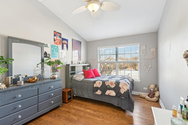 bedroom with ceiling fan, wood-type flooring, and lofted ceiling