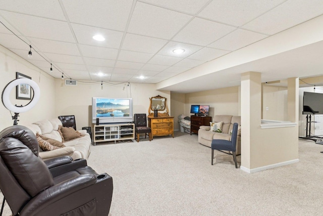 living room featuring carpet flooring and a paneled ceiling