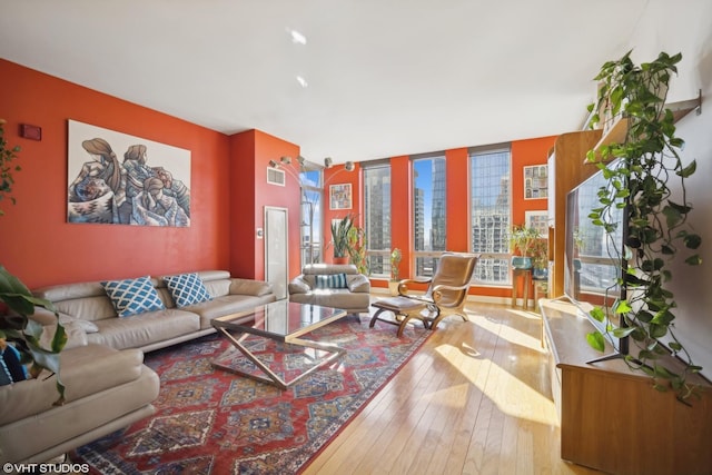 living area featuring light wood finished floors and floor to ceiling windows