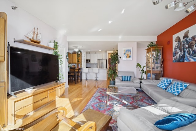 living area with visible vents and light wood finished floors