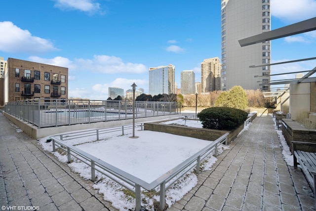 surrounding community with a city view and fence