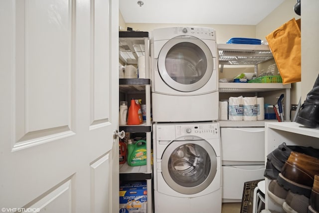 laundry room with stacked washer and dryer and laundry area