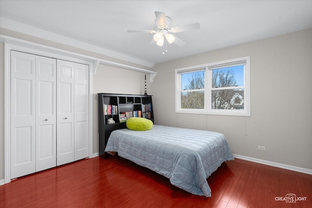 bedroom with ceiling fan, dark hardwood / wood-style flooring, and a closet